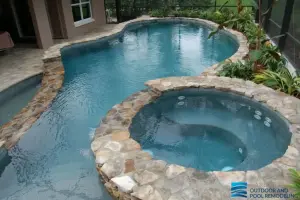 Freeform pool remodeling with natural rock coping and stacked stone water wall