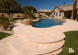 Travertine paver pool deck with raised steps and custom pool