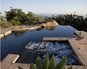 Infinity pool with attached spa and mountain views