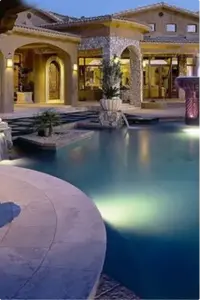 Pool plastering project with custom pool finish, underwater lighting, and stone pillars
