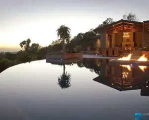 Pool remodeling project featuring hilltop infinity pool and outdoor fireplace